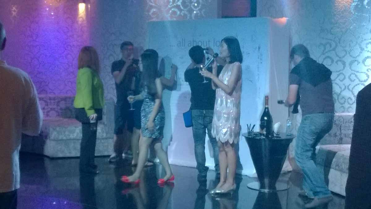 Host addresses guests at the wrap party for a Chinese production company in Prague