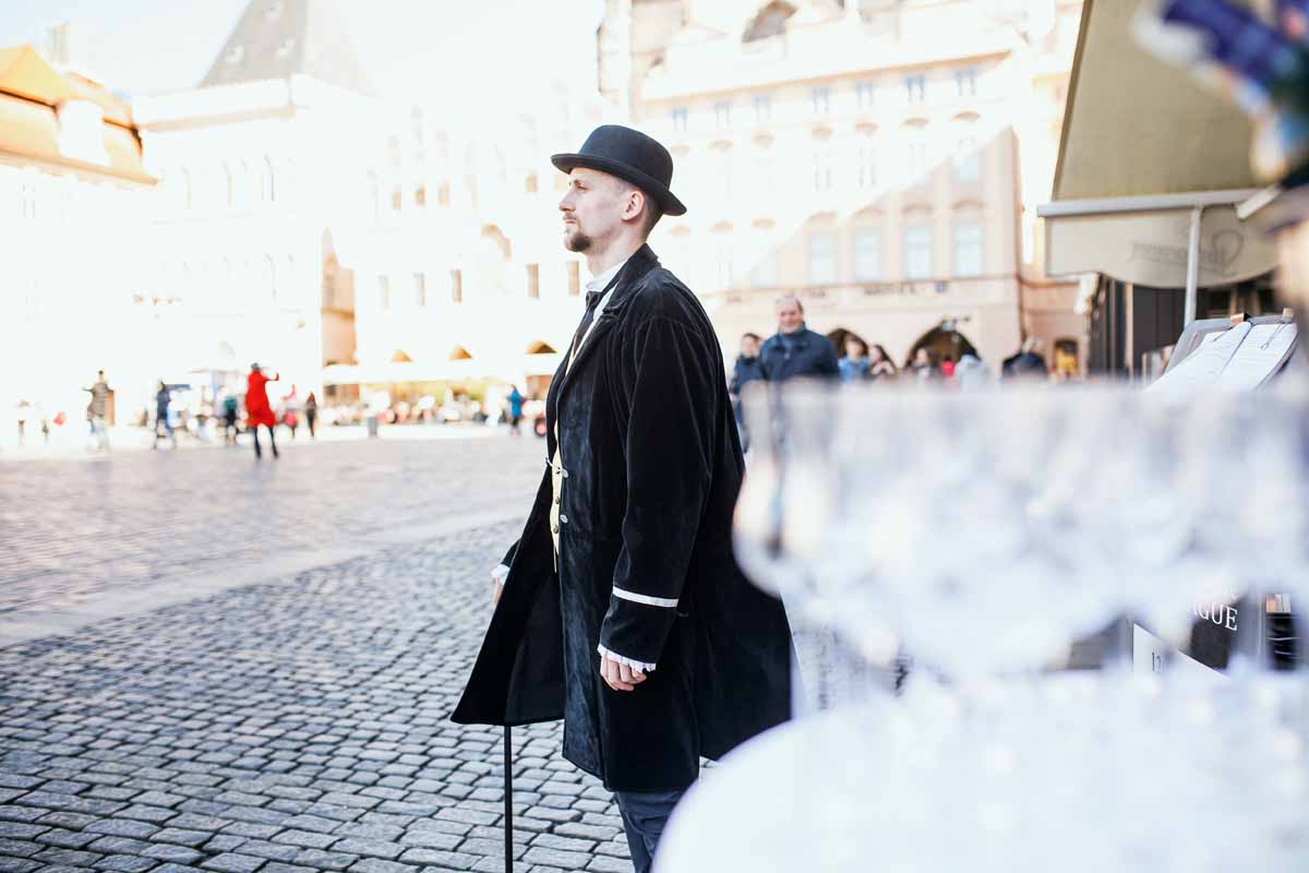 Hostess in historical costume is waiting for teambuilding group during a program organized in Prague