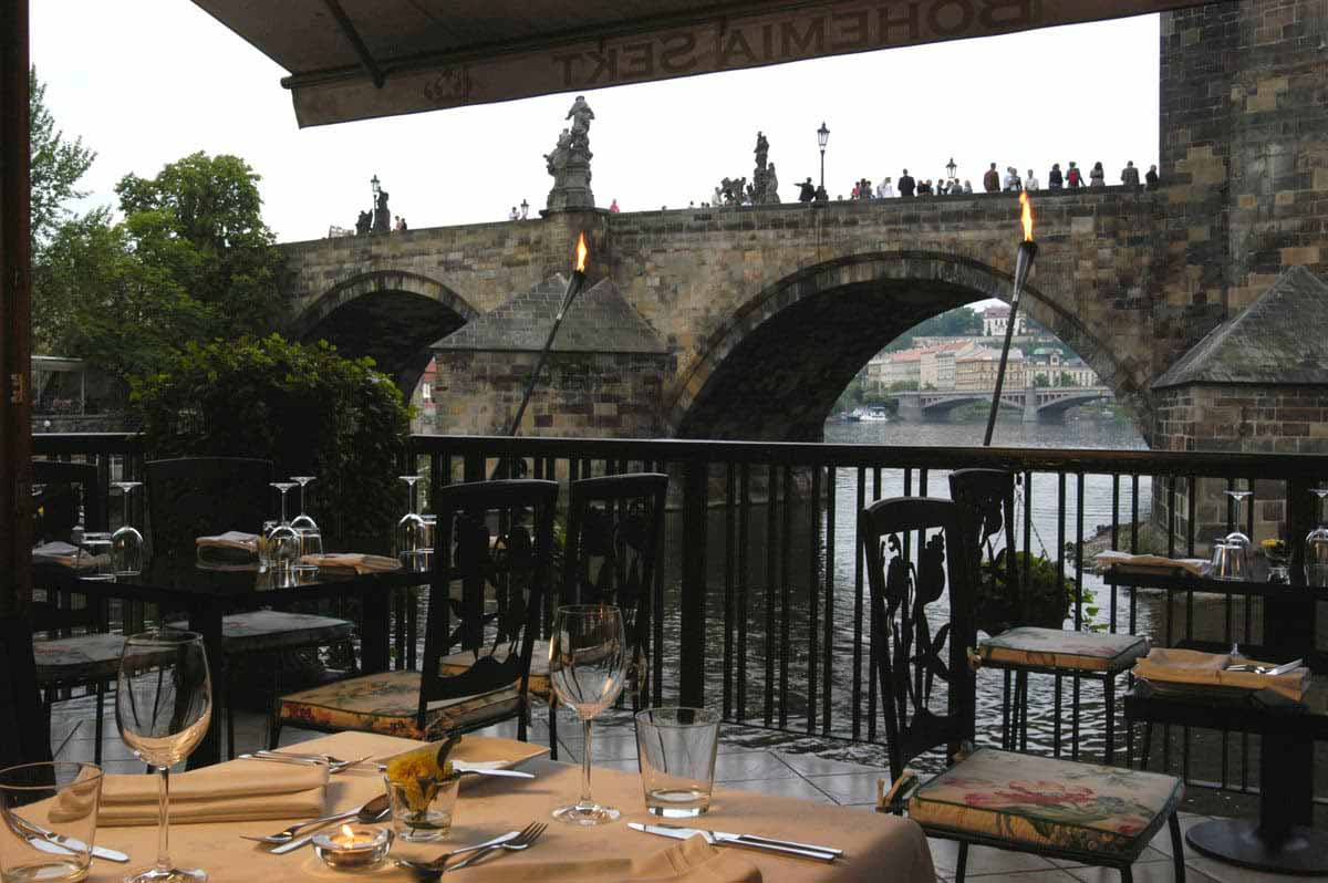Prague incentive program fine restaurant summer garden by Charles bridge